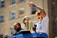 Stephen Curry #30 of the Golden State Warriors holds the championship trophy.